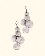 Silver-plated disc drop earrings on neutral background