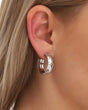 Silver hammered hoop earring worn on ear