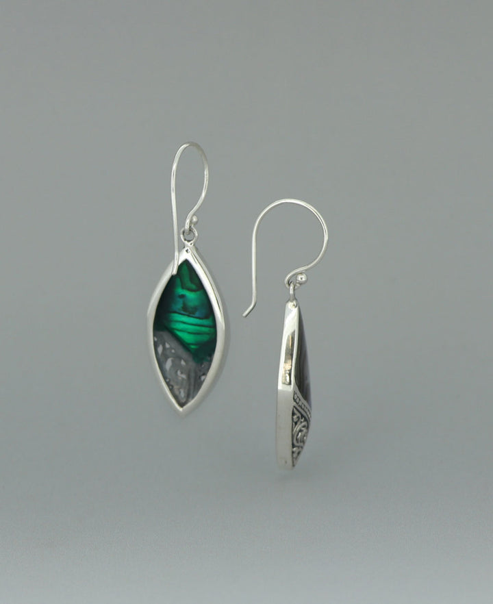 Full view of the sterling silver Abalone Shell earrings against a light background, emphasizing the intricate silver filigree and vibrant shell inlay
