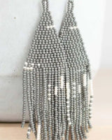 Gray beaded necklace on a light background