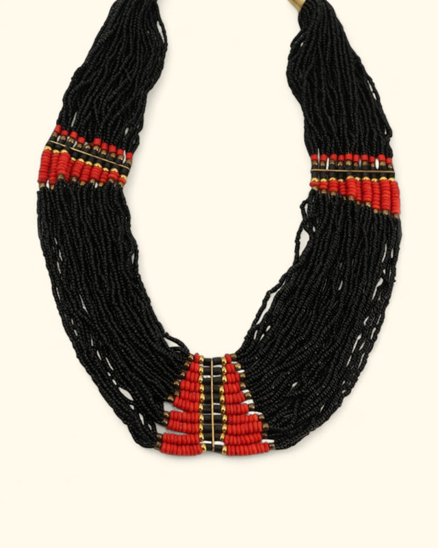 Black beaded necklace with red accents on a white background