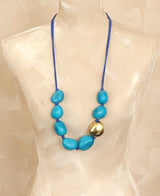Cultural Elements blue tagua nut statement necklace with gold plated pod and blue suede cord.