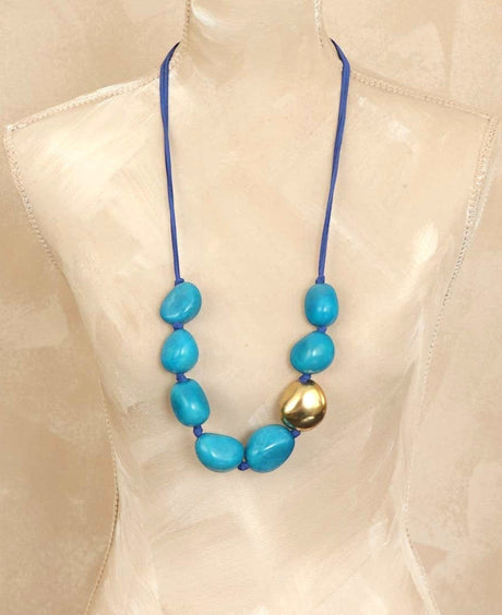 Cultural Elements blue tagua nut statement necklace with gold plated pod and blue suede cord.