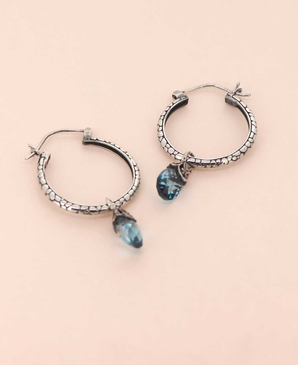 Sterling silver hoop earrings with blue topaz