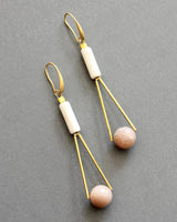 Long gold earrings with soft pink and cream natural stones
