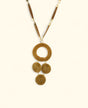 Handwoven necklace with cascading natural medallions