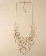 Gold-tone multi-layered hammered ring necklace.