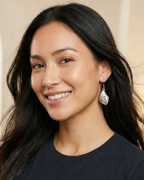 Model wearing cultural artisan earrings