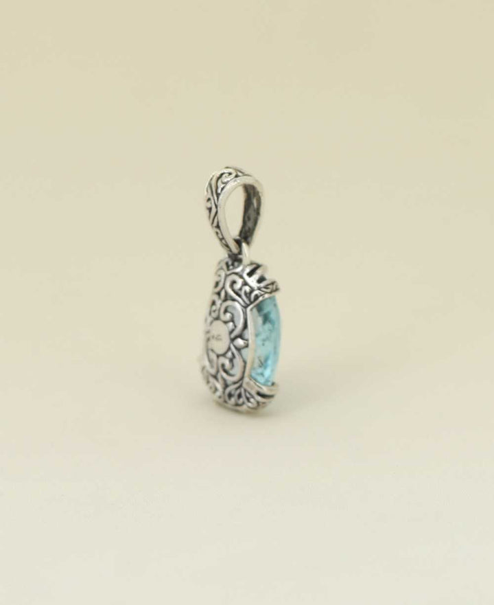 Filigree silver frame blue topaz pendant