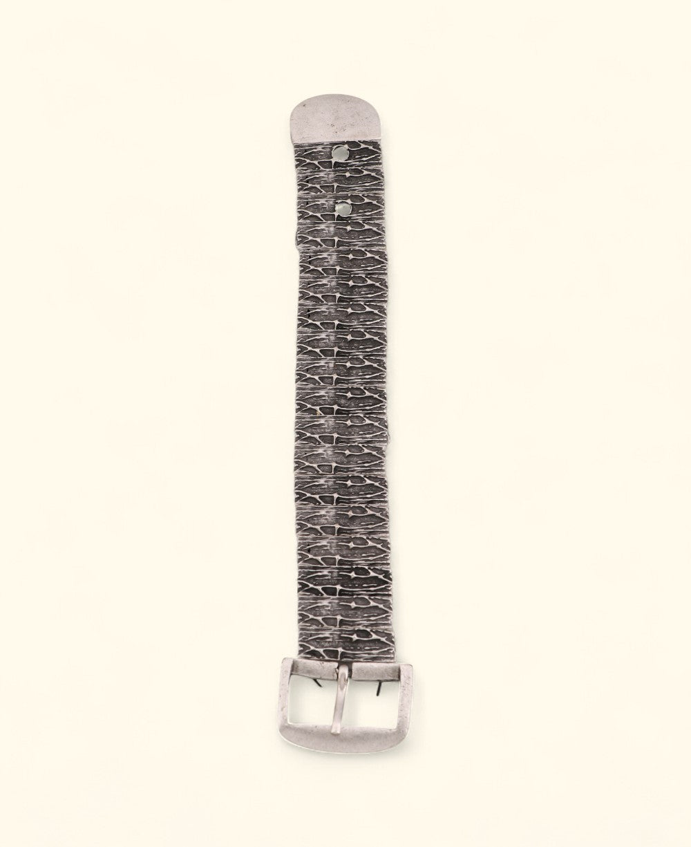 Pewter belt-inspired stretch bracelet on neutral background