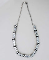 22-inch geometric pewter necklace with lobster clasp.