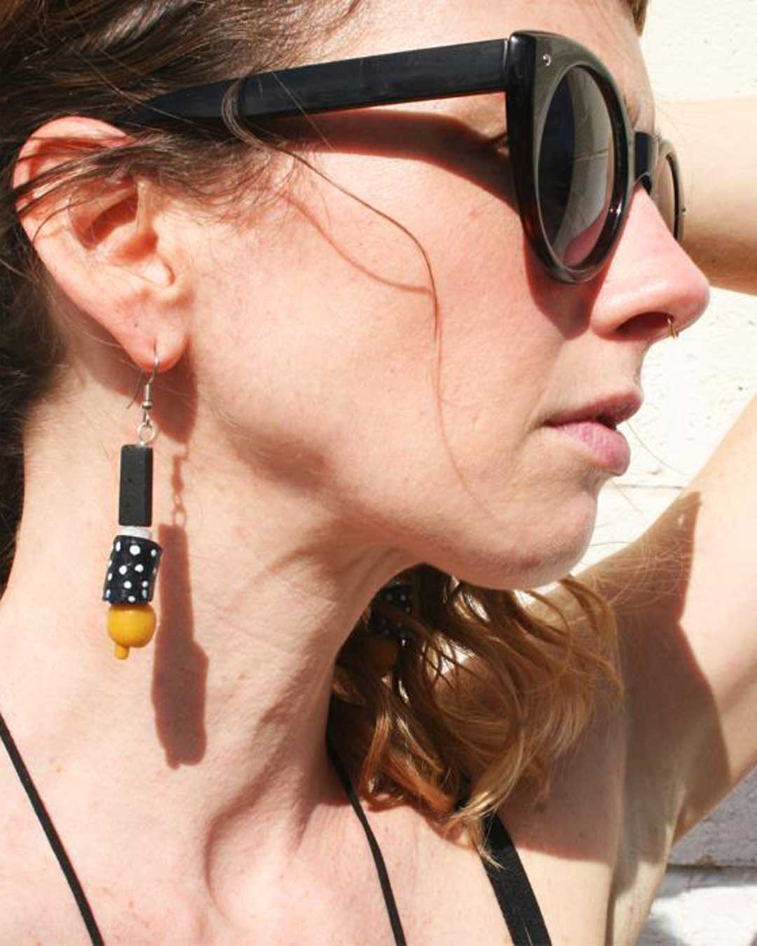 Black and white dotted earrings with yellow accent bead