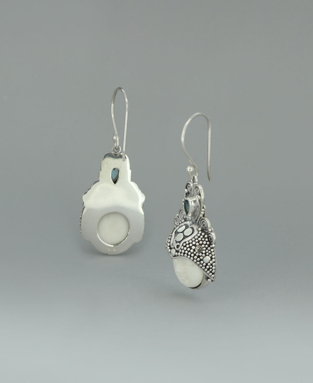 Sterling Silver Balinese Goddess Face Earrings on a light background, emphasizing the lustrous silver and tranquil aura of the design