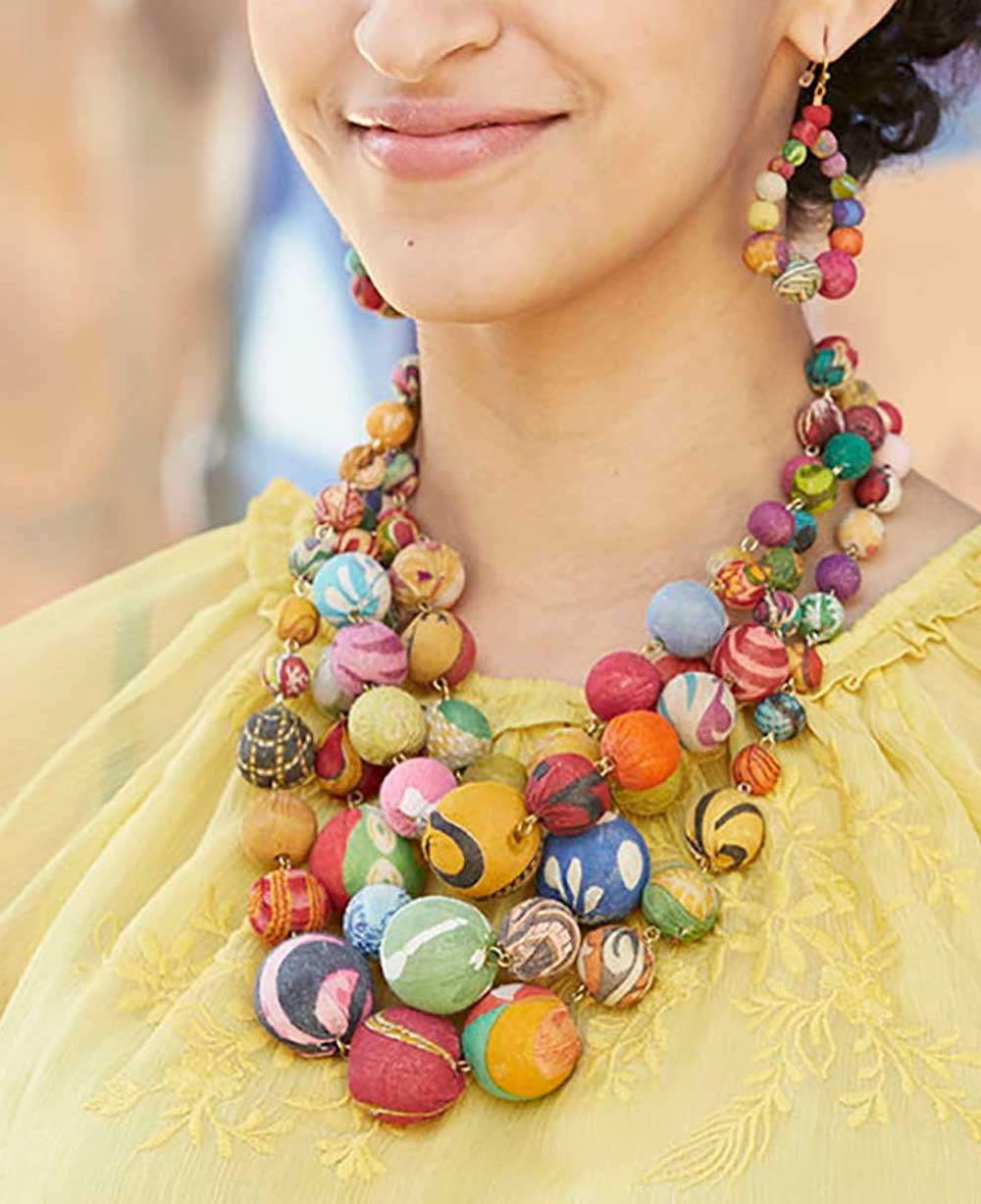 Woman wearing the Kantha bead necklace, complementing her bohemian attire