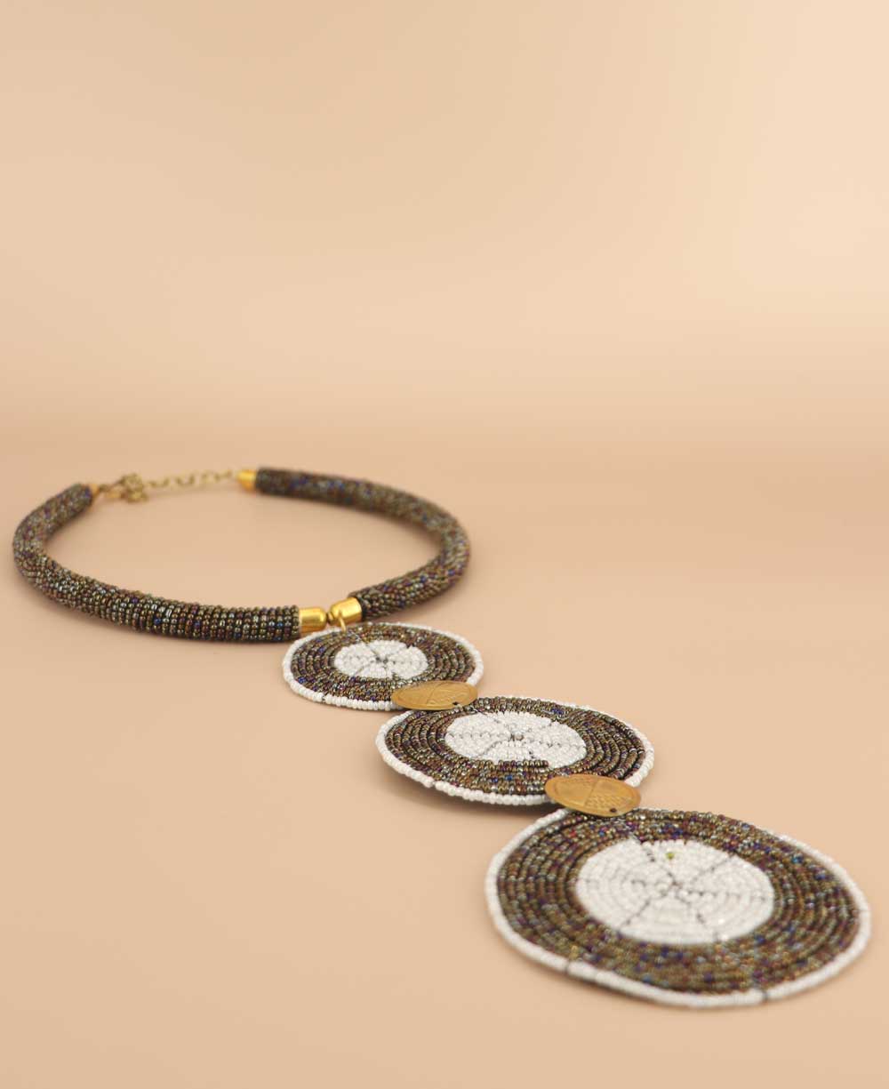 Side view of Kenyan artisan jewelry with brass shilling