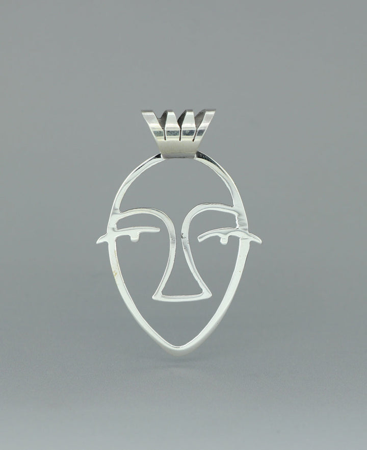 Close-up image of the sterling silver Picasso Face cut-out pendant