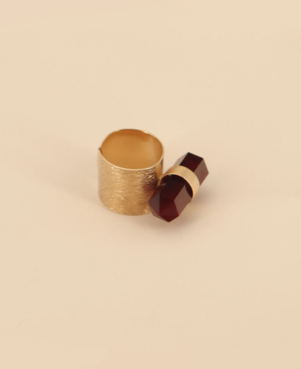 Close-up view of the vibrant red onyx point set in a romantic rose gold plated brass ring