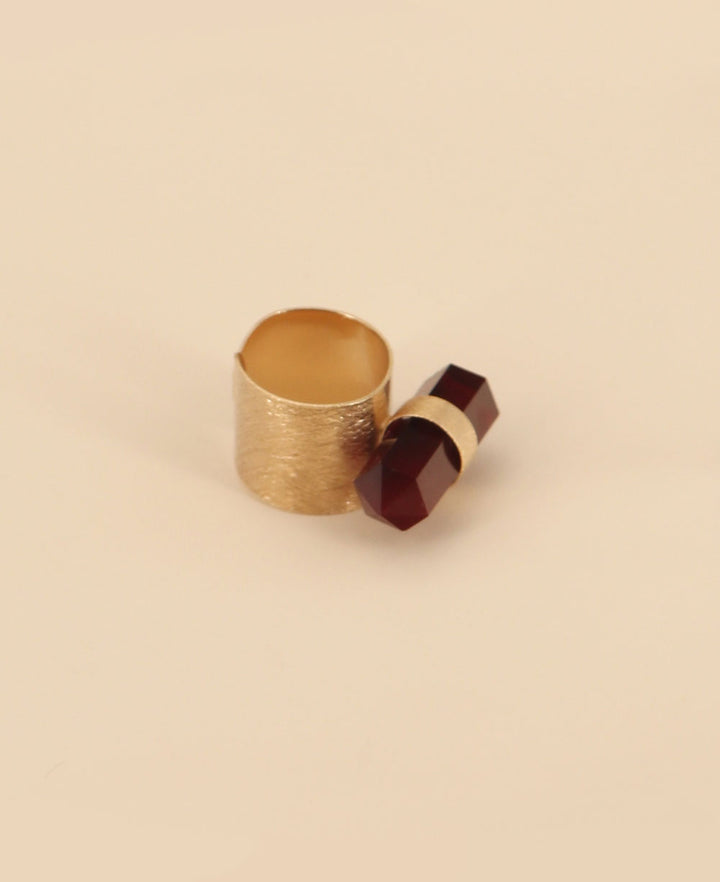 Close-up view of the vibrant red onyx point set in a romantic rose gold plated brass ring