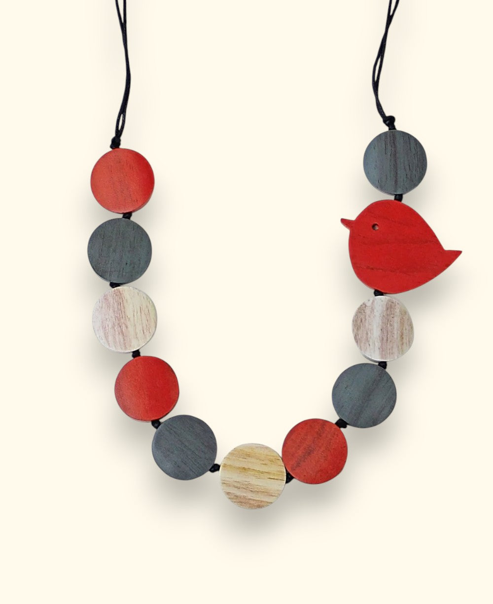 Handmade wooden bird necklace with red, grey, and beige beads
