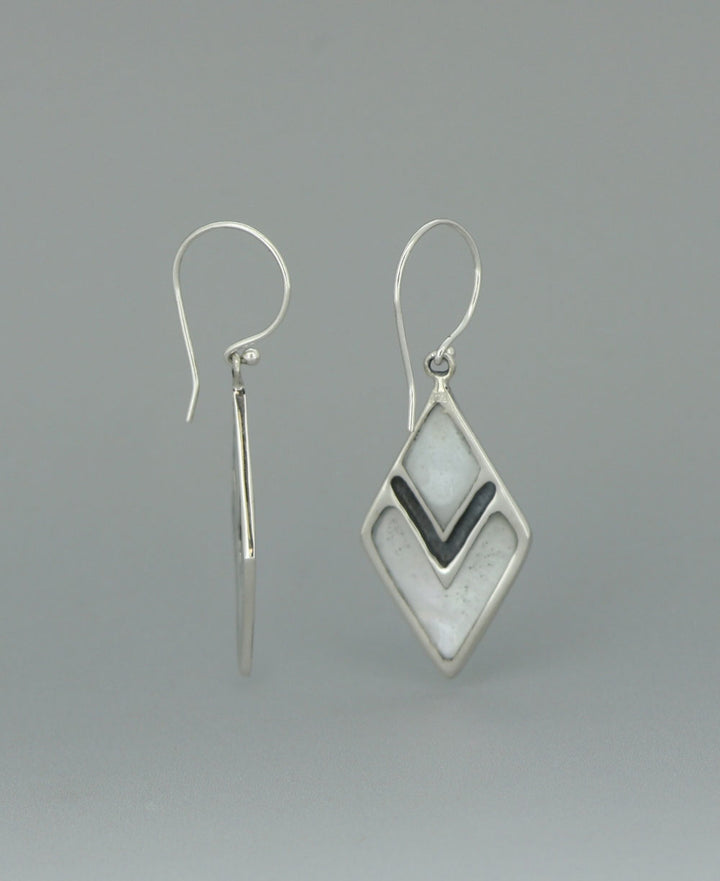 Sterling silver Mother of Pearl earrings, highlighting the elongated diamond shape and the contrast between the lustrous shell and sleek silver frame