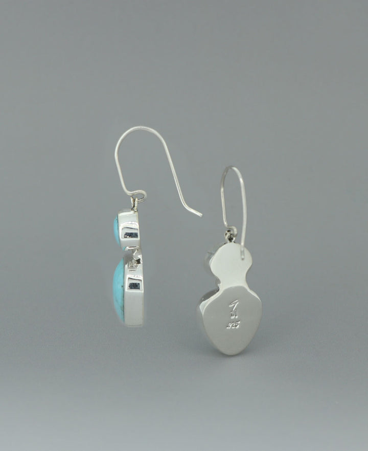 Sterling silver Genuine Turquoise dangling earrings, showcasing the unique hinged design and natural turquoise variations