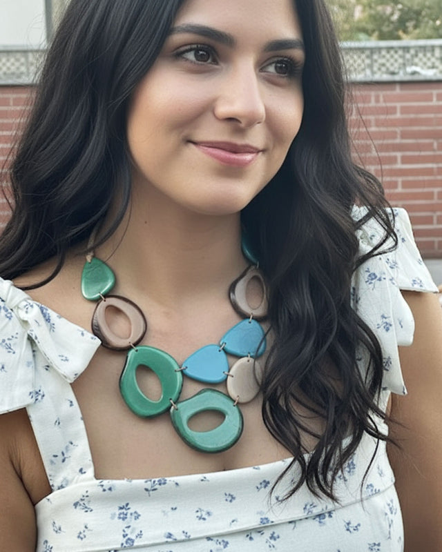 Woman wearing a colorful tagua necklace with a blurred background