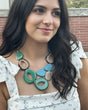 Woman wearing a colorful tagua necklace with a blurred background
