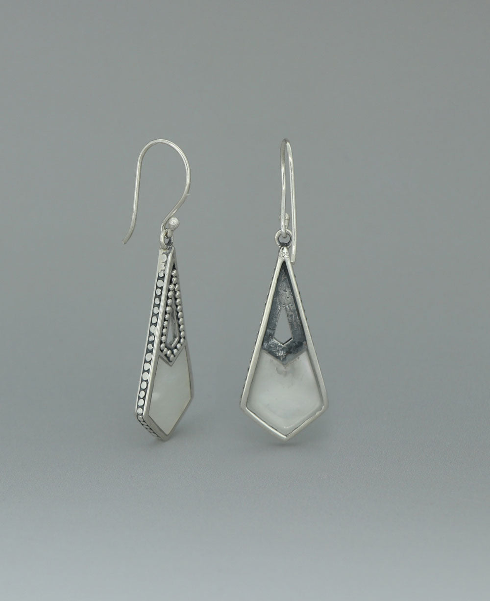 Sterling silver Mother of Pearl earrings, emphasizing the beaded silver frame and the striking contrast between the lustrous shell and geometric design