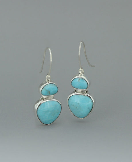 Full view of the sterling silver Genuine Turquoise dangling earrings against a light background, emphasizing the vibrant Kingman turquoise