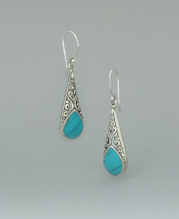 Full view of the sterling silver Reconstituted Turquoise earrings against a light background, showcasing the intricate filigree work and vibrant turquoise inlay