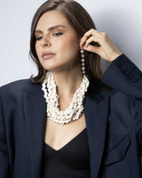 Cultural Elements soft white wood disc necklace with horn closure, twisted strands, 20 inches.