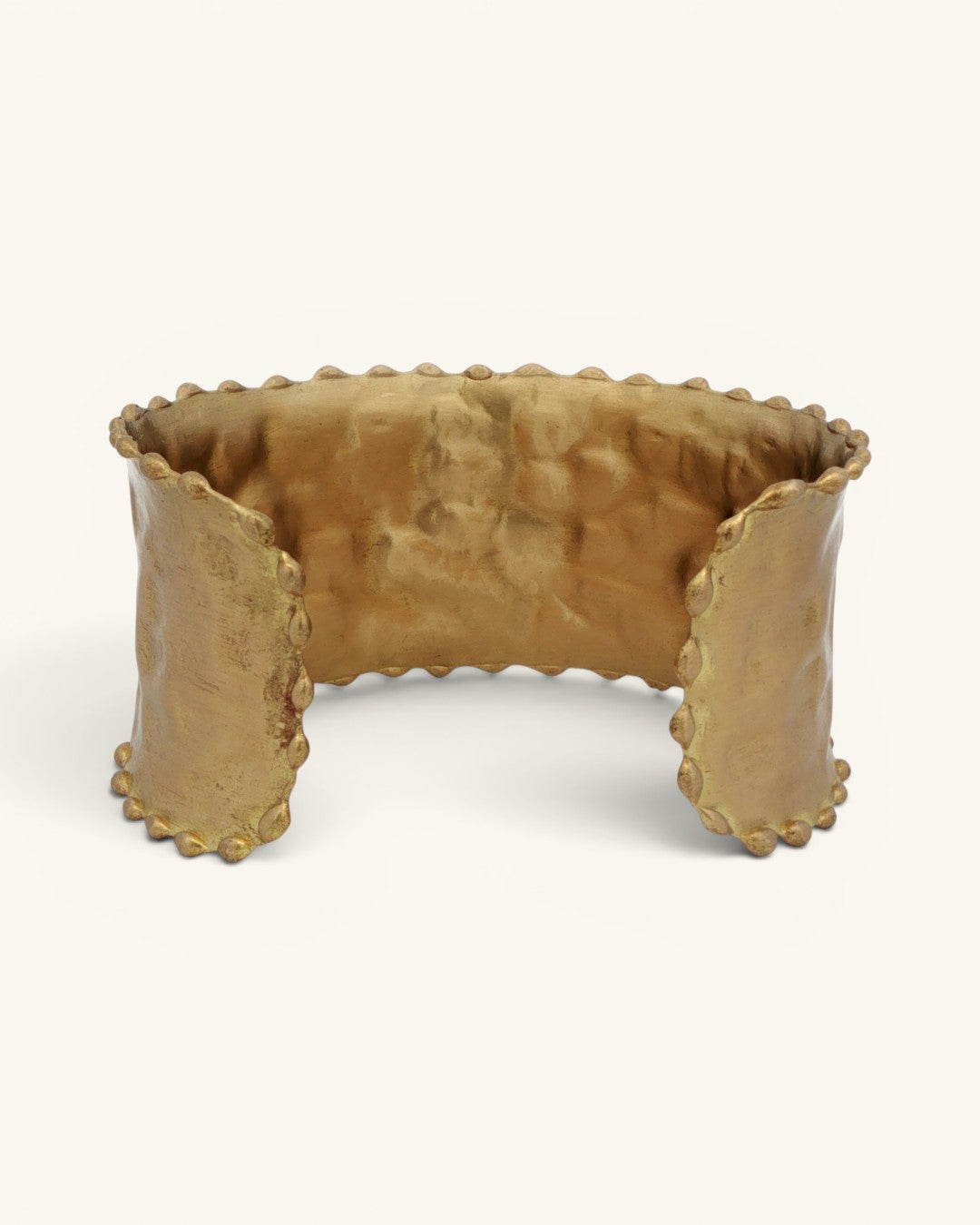 Beaded edge hand-hammered brass cuff bracelet viewed from above showing curved interior and scalloped bead trim on all edges
