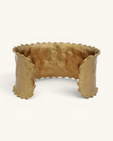 Beaded edge hand-hammered brass cuff bracelet viewed from above showing curved interior and scalloped bead trim on all edges