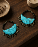 Black and Aqua Handcrafted Thread-Wrapped Hoop Earrings — earrings, editorial wood console lifestyle photo
