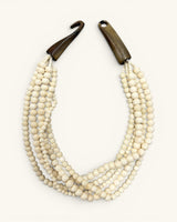 Indian bone bead 5-strand necklace laid flat on white background with horn hook-and-loop closure shown open and unlatched