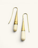 Tosha bone and brass threader drop earrings on white background, angled view highlighting elongated bone drop tips and threader wire