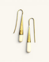 Tosha bone and brass threader drop earrings pair on white background, showing brass cone body and rounded bone tips