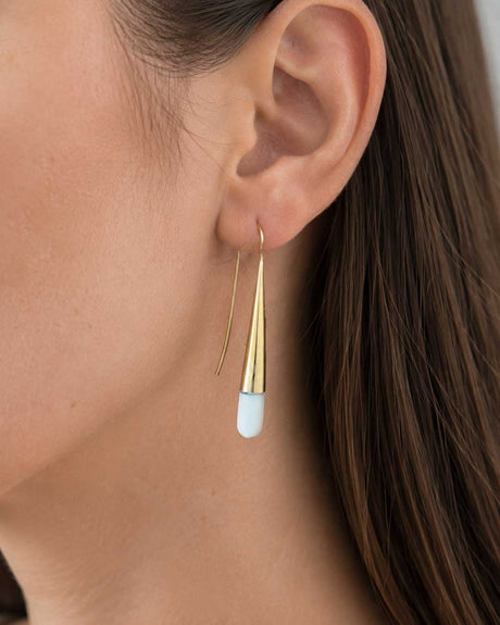 Tosha bone and brass threader drop earring worn on model's ear, close-up side view showing full drop length