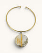 Brass collar choker necklace with round Ankole horn disc pendant and vertical brass bar accent, front view on white background