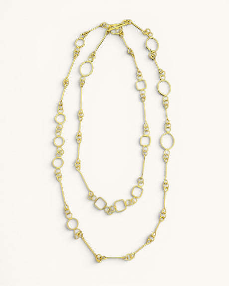 Handmade brass link geometry long wrap necklace laid flat on white background, showing circular and square links in double loop