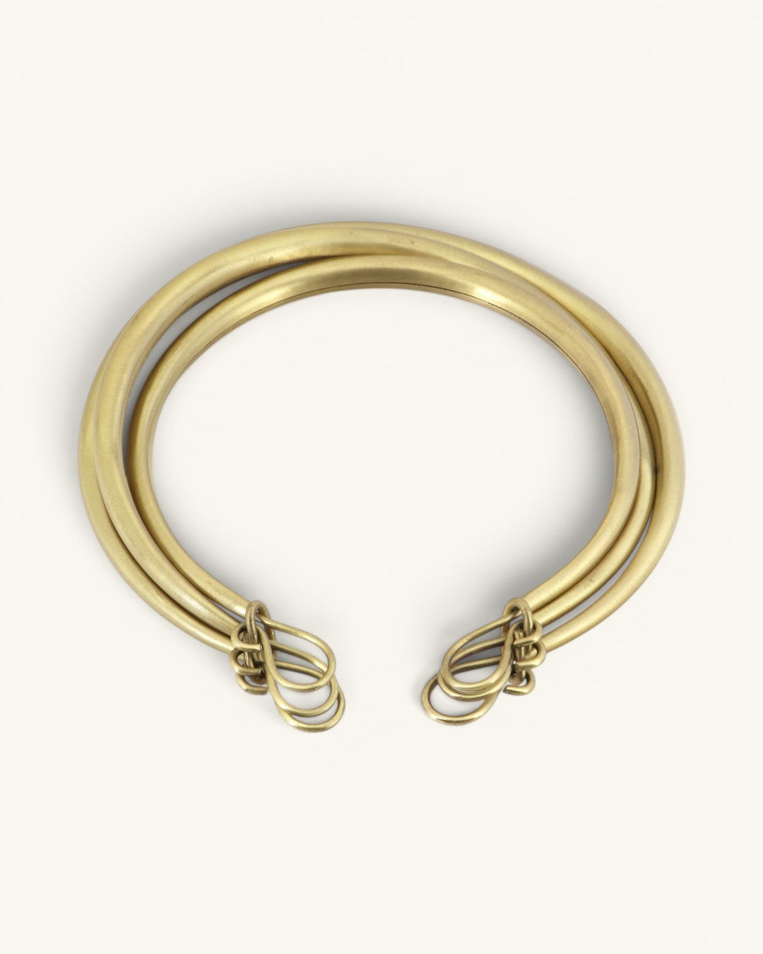 Hand-beaten brass triple-strand collar necklace flipped to show back side with hook-and-loop wire clasp detail