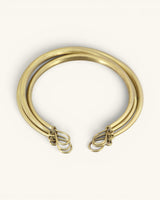 Hand-beaten brass triple-strand collar necklace flipped to show back side with hook-and-loop wire clasp detail
