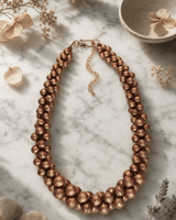 Copper-Tone Layered Statement Necklace — necklaces, editorial marble lifestyle photo