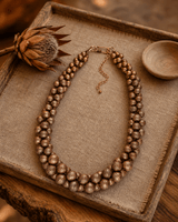 Copper-Tone Layered Statement Necklace — necklaces, vibey macro bokeh linen tray lifestyle photo
