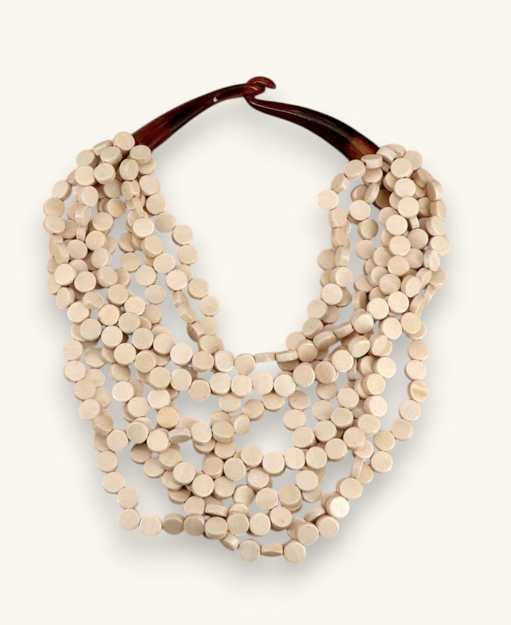 Cultural Elements beige wood disc layered necklace with horn eye and hook closure, 21 inches.