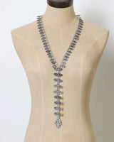 Cultural Elements antique silver tone lariat necklace with ornate Hamsa pendant and repeating links.