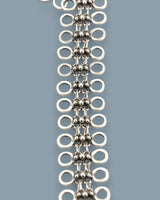Cultural Elements silver-tone metal alloy lariat necklace with cutout discs and bead-like connectors. Modern Y-shaped silhouette.