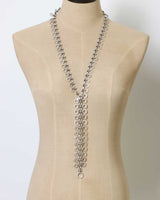 Cultural Elements silver-tone metal alloy lariat necklace with cutout discs and Y-shaped silhouette.