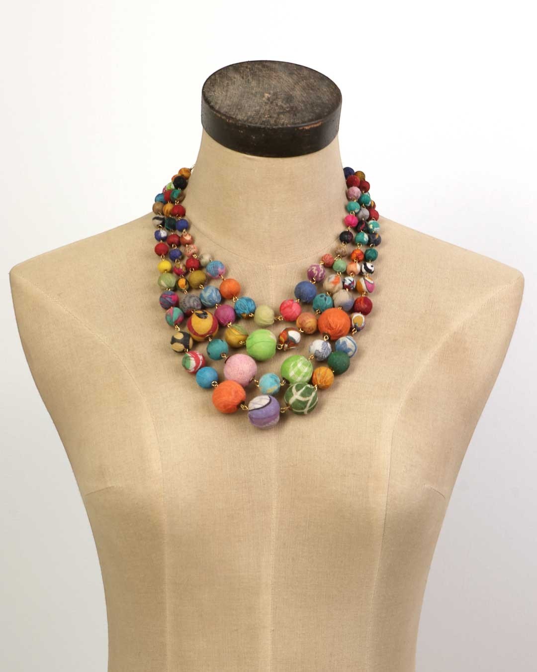 Cultural Elements multi-strand statement necklace with colorful, recycled textile beads in a layered design.