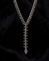 Cultural Elements antique silver tone lariat necklace with ornate Hamsa pendant and repeating links.